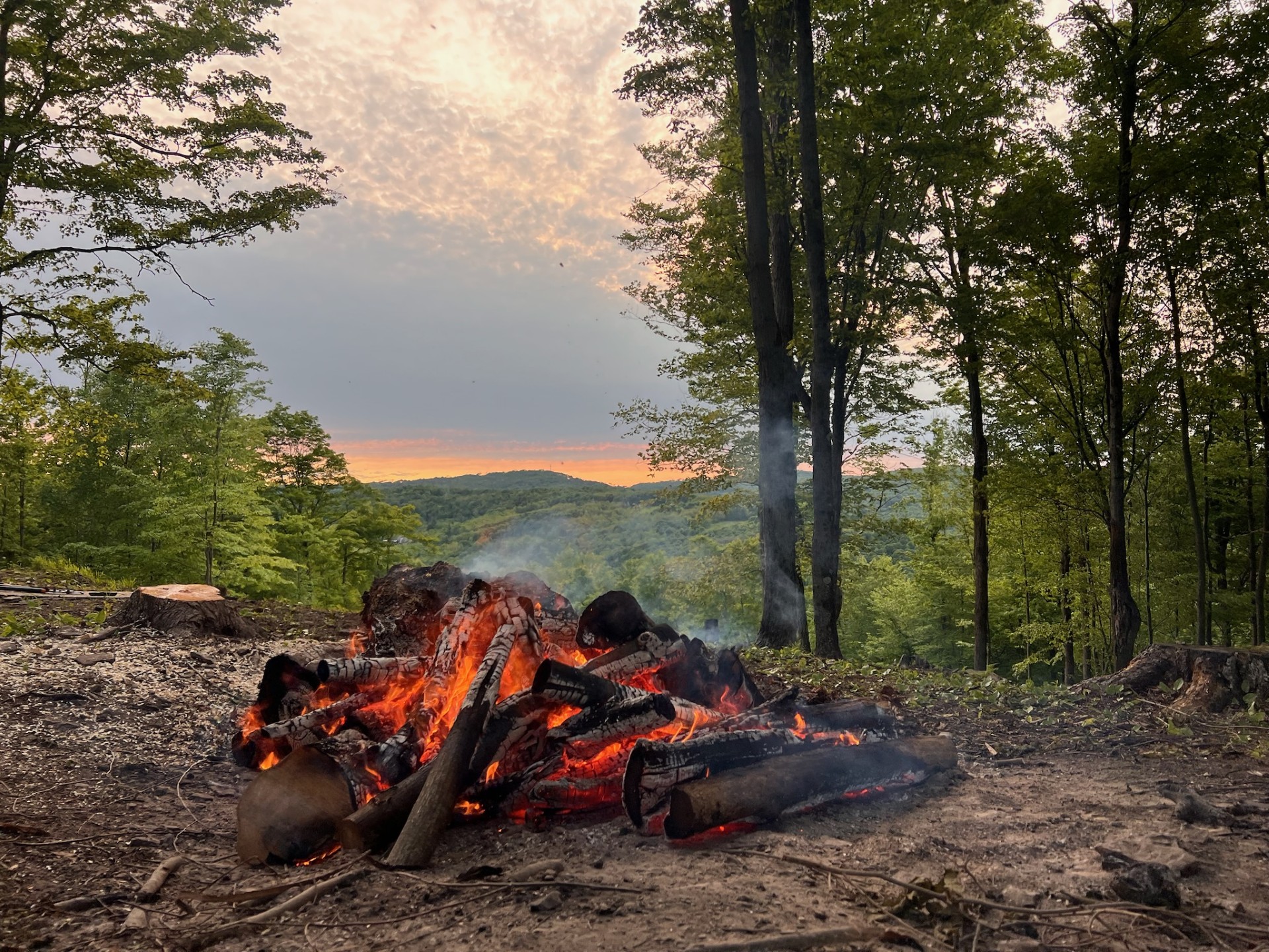 A fire overlooking the mountain at sunset